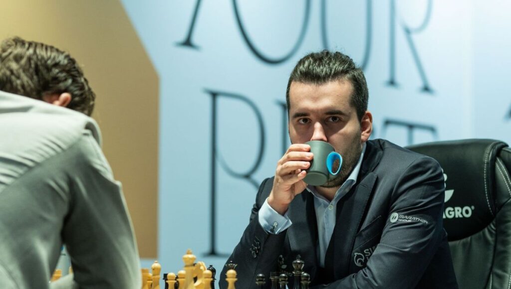 Ian Nepomniachtchi drinking tea during a game of chess to stay calm and focused